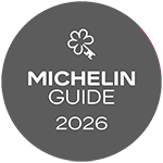 The Michelin Guide 2026 logo with a clover icon in white on a dark gray background. logo on footer section.