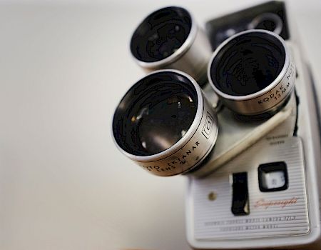Close-up of a Kodak binoculars/optical device, showing multiple black eyepiece lenses against a white background.