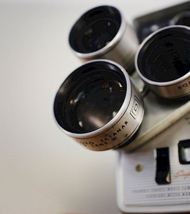 Close-up of a Kodak binoculars/optical device, showing multiple black eyepiece lenses against a white background.