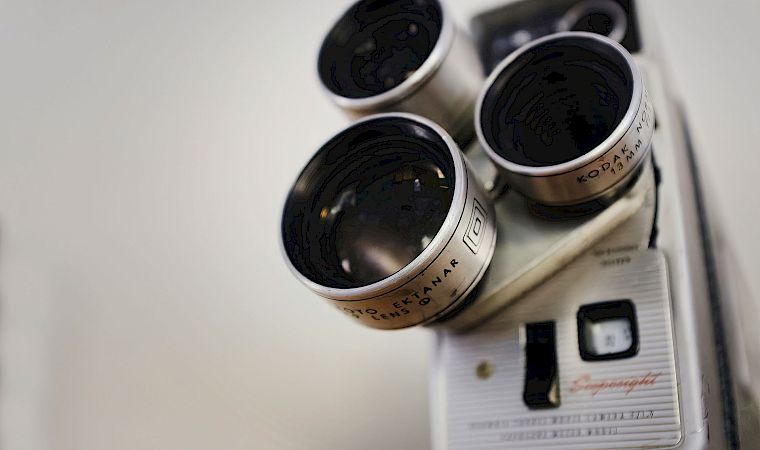 Close-up of a Kodak binoculars/optical device, showing multiple black eyepiece lenses against a white background.